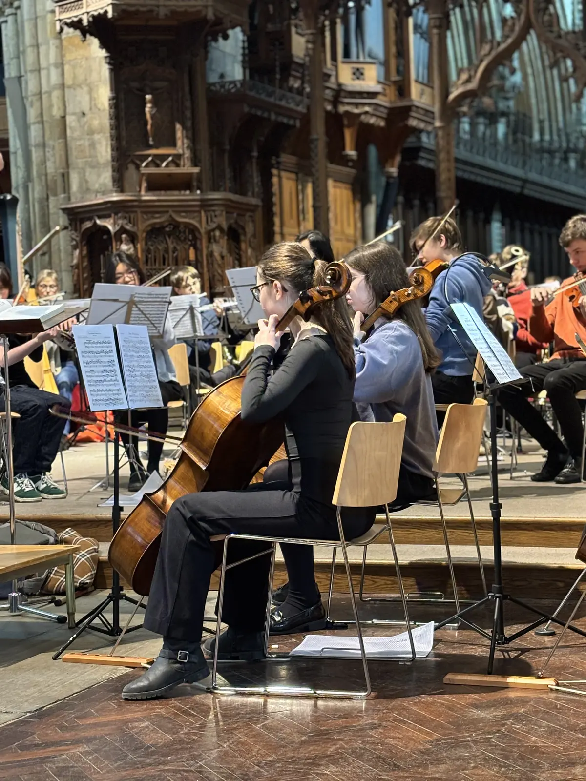 York Youth Orchestra string players within the full orchestra at Selby Abbey
