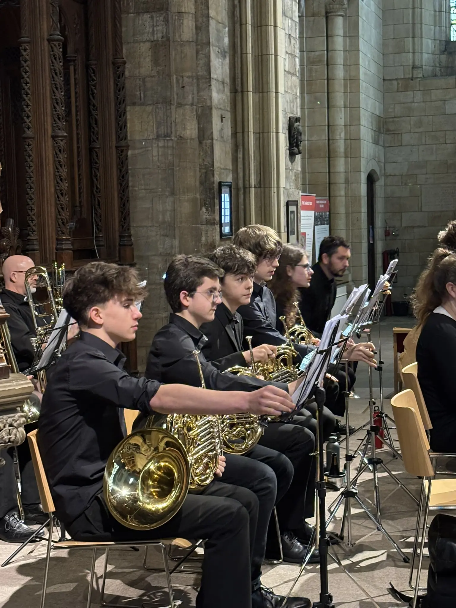 York Youth Orchestra wind players within the full orchestra at Selby Abbey